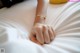 A woman's hand on a bed with a yellow banana.