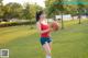 A woman holding a basketball in a park.